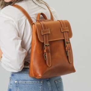 Medium-sized leather backpack convertible into a crossbody bag tan color wearing aw a backpack