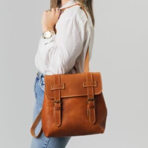 Medium-sized leather backpack convertible into a crossbody bag tan color wearing as crossbody